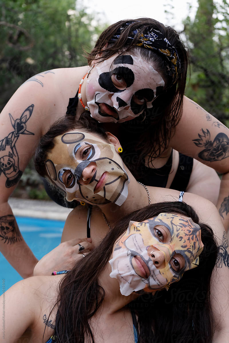 Women having fun wearing face beauty mask for skin care therapy