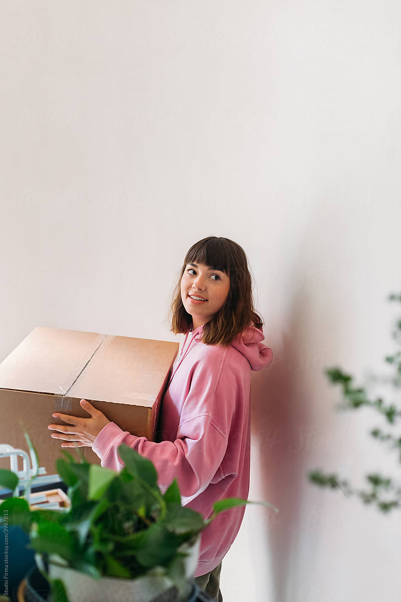 Woman Carrying Box With Houseplant