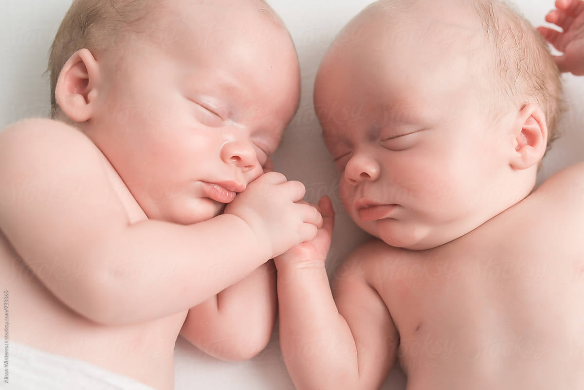 Newborn Twin Brothers Holding Hands
