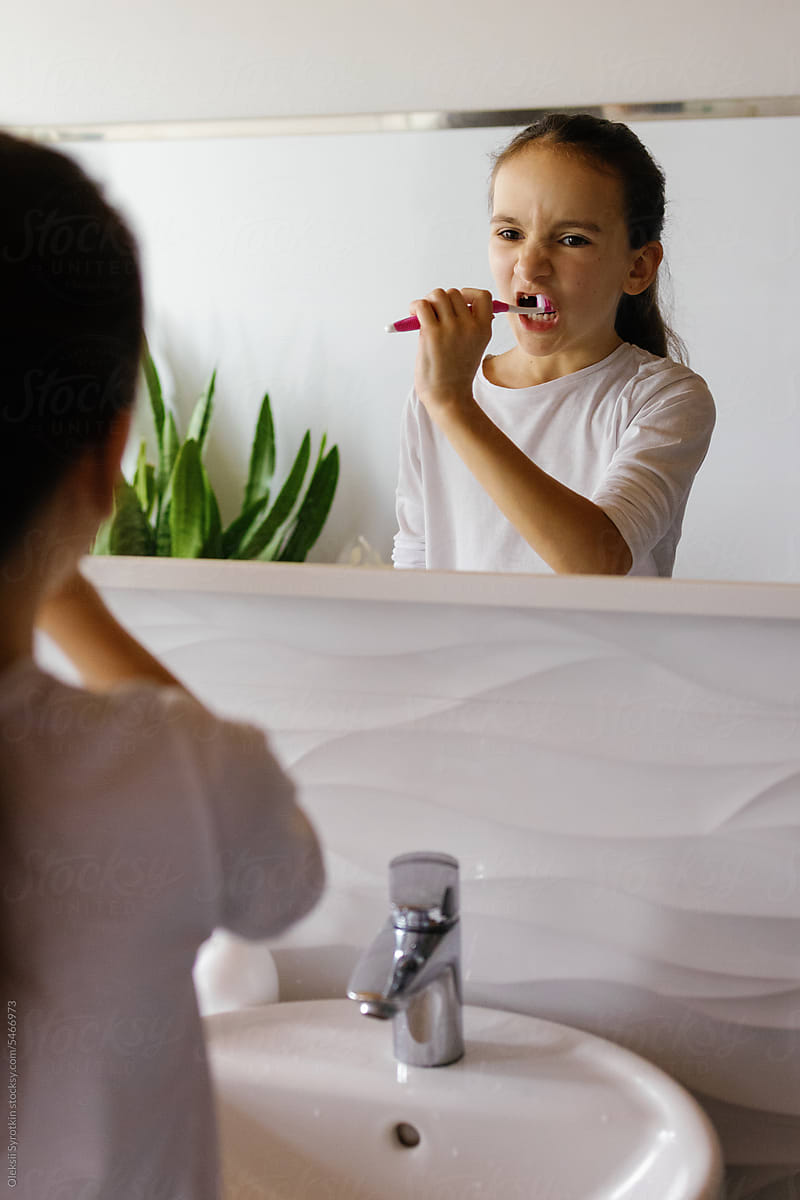 Preteen bathroom brushing teeth habit reflection
