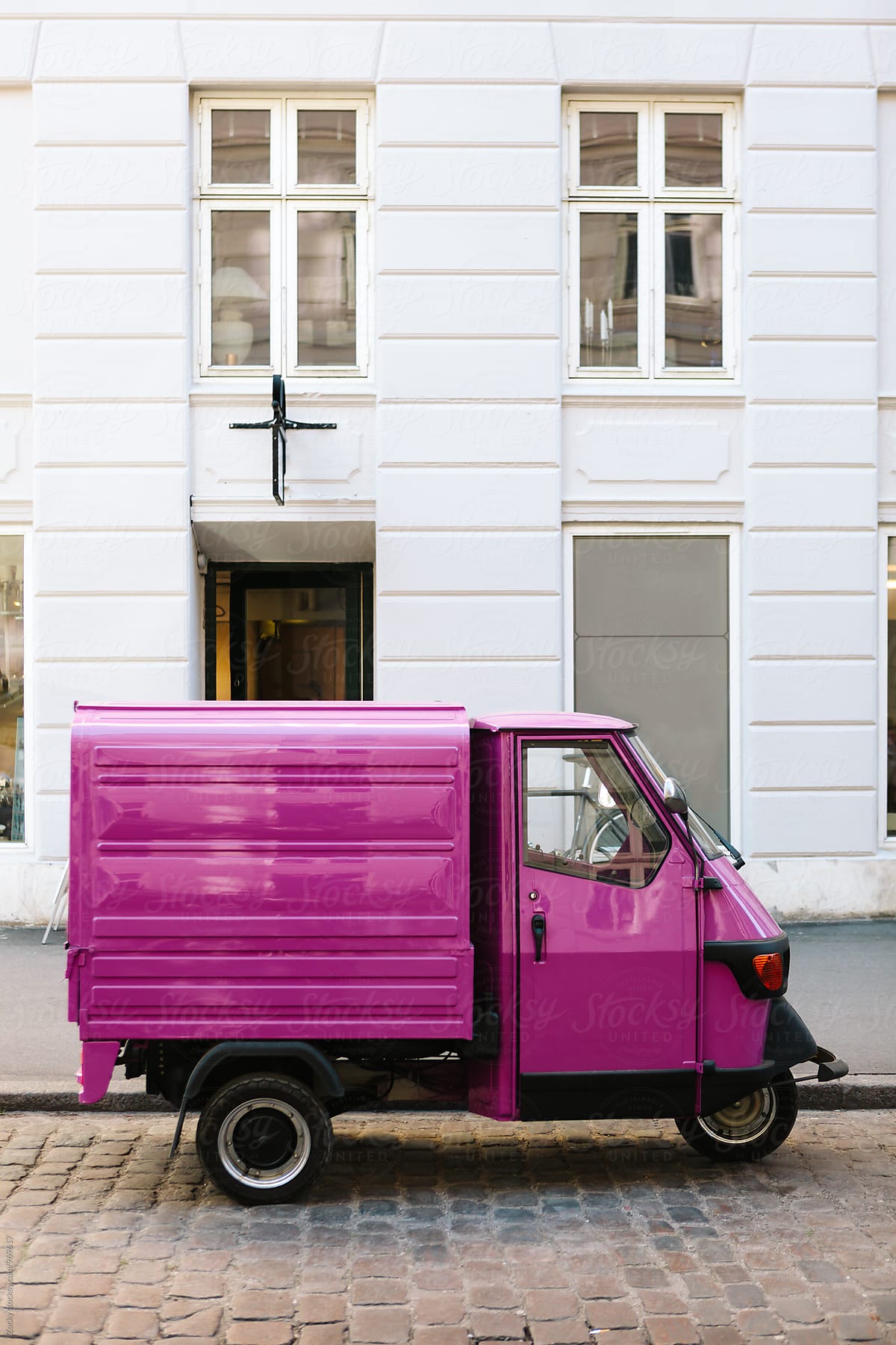 Pink three-wheeled light commercial vehicle