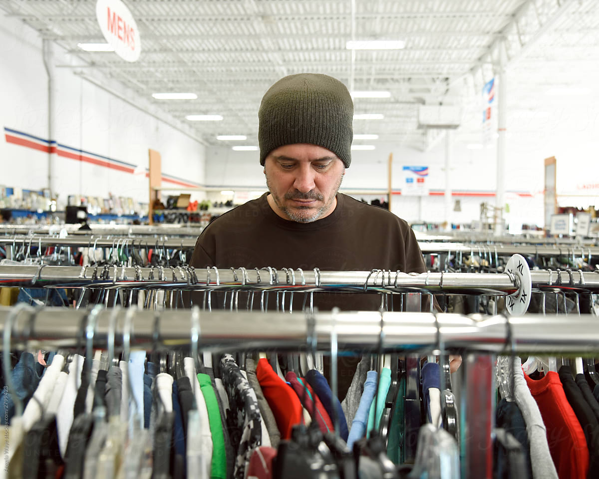 Man Shopping at Store Looking at Clothes