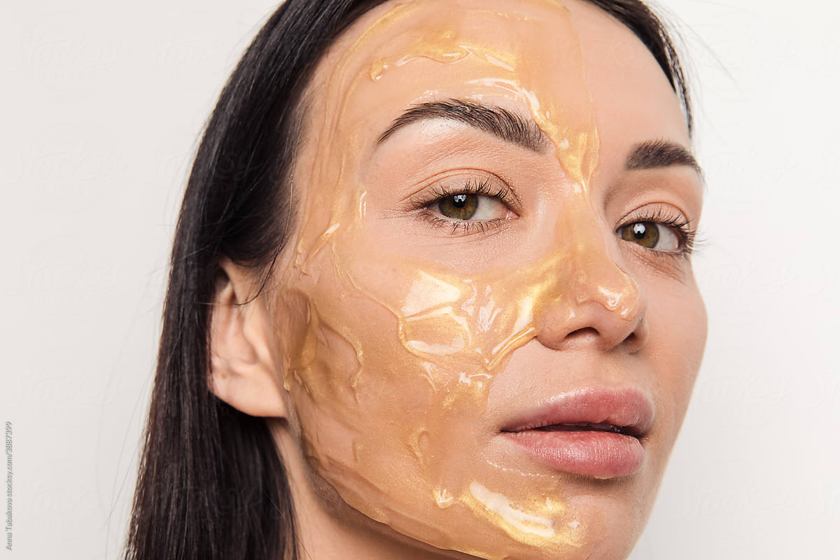 Woman with gold gel facial mask