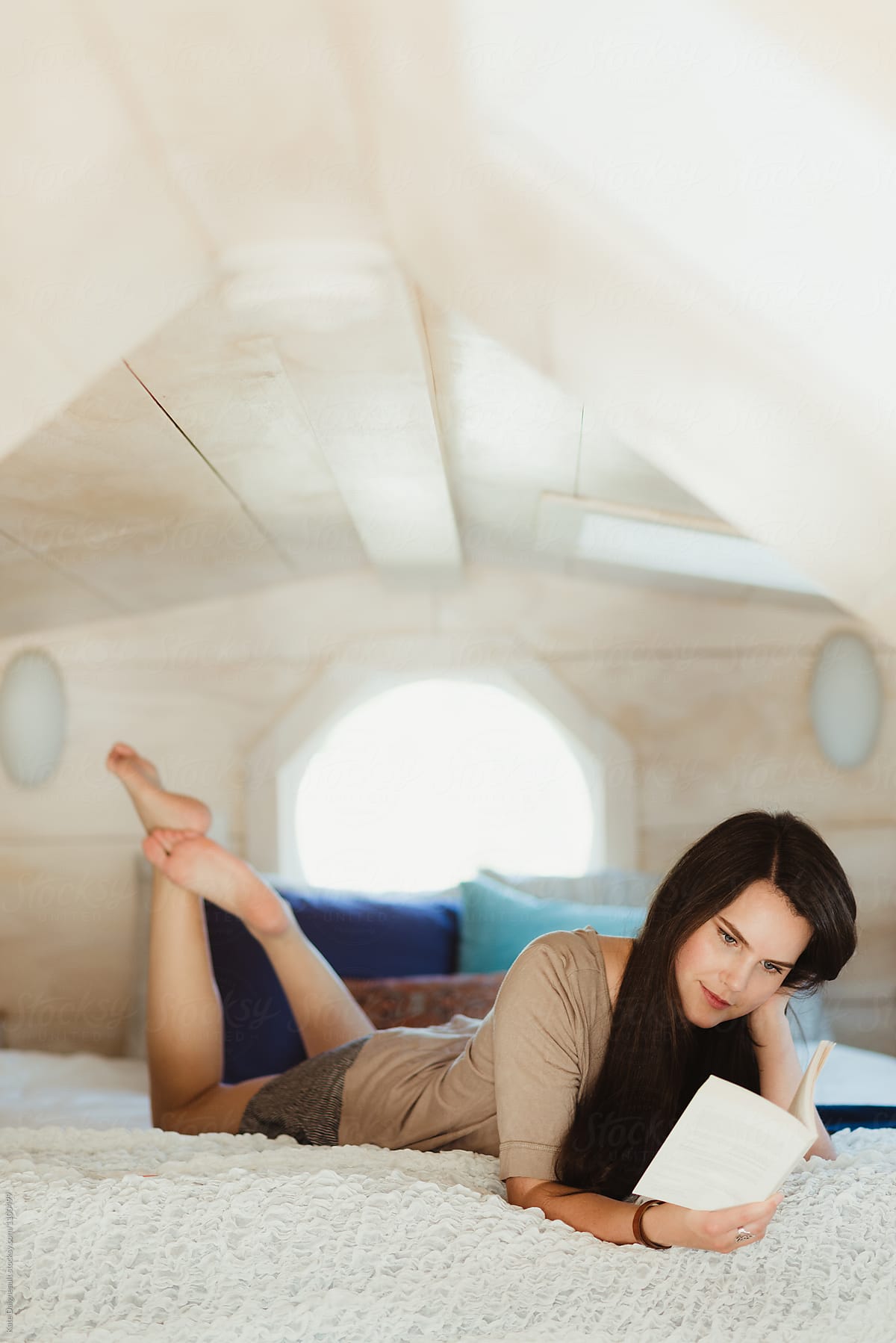Young woman reading in loft space