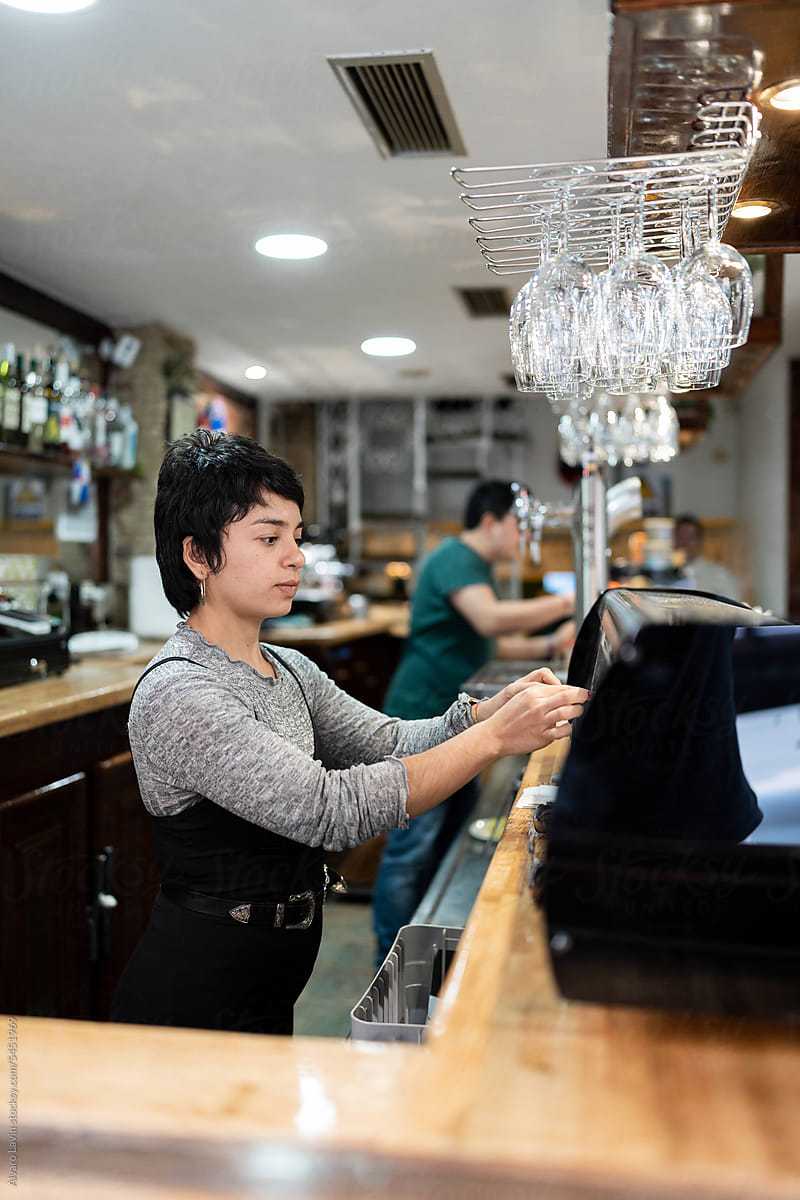 Woman working at a bar.