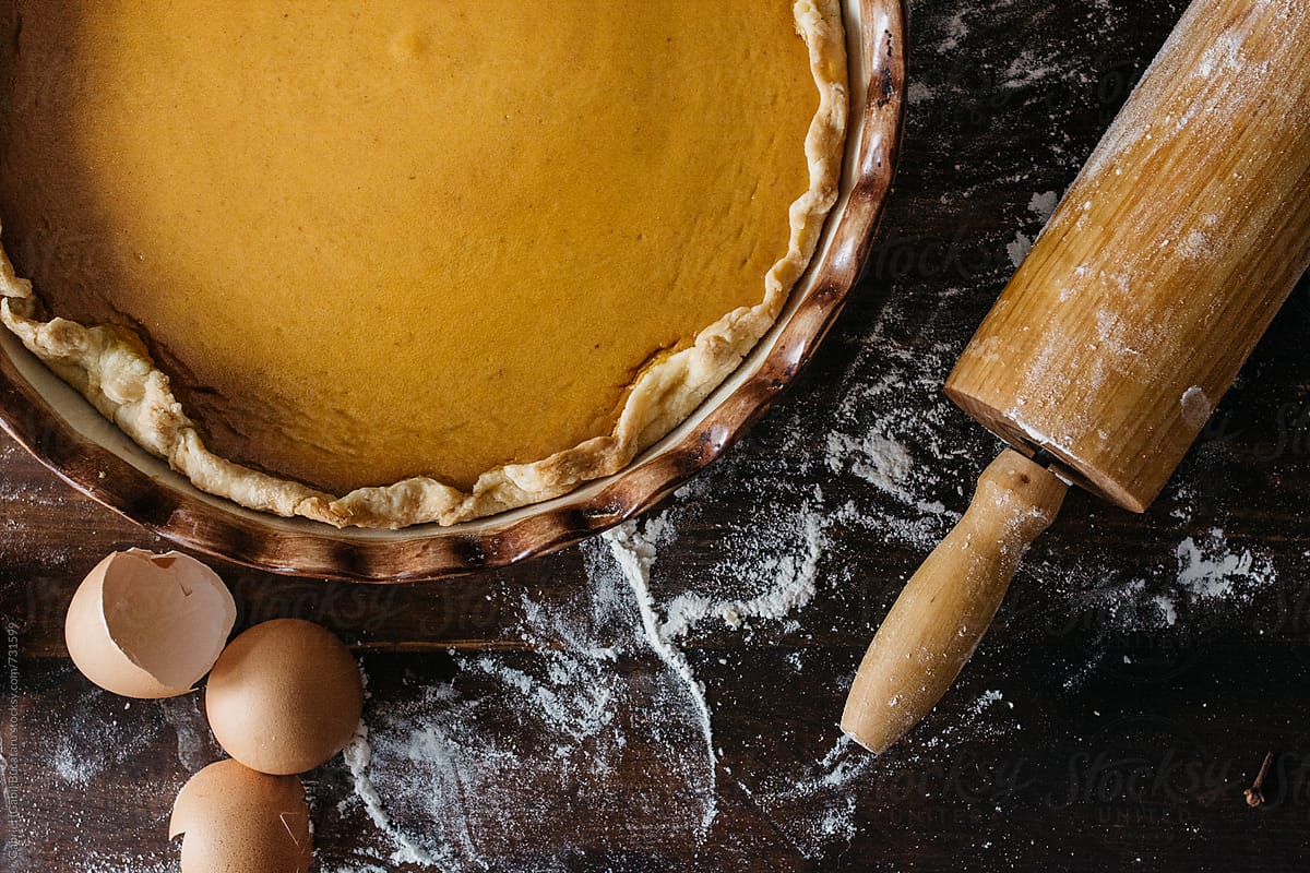 Freshly baked pumpkin pie and egg shells from above