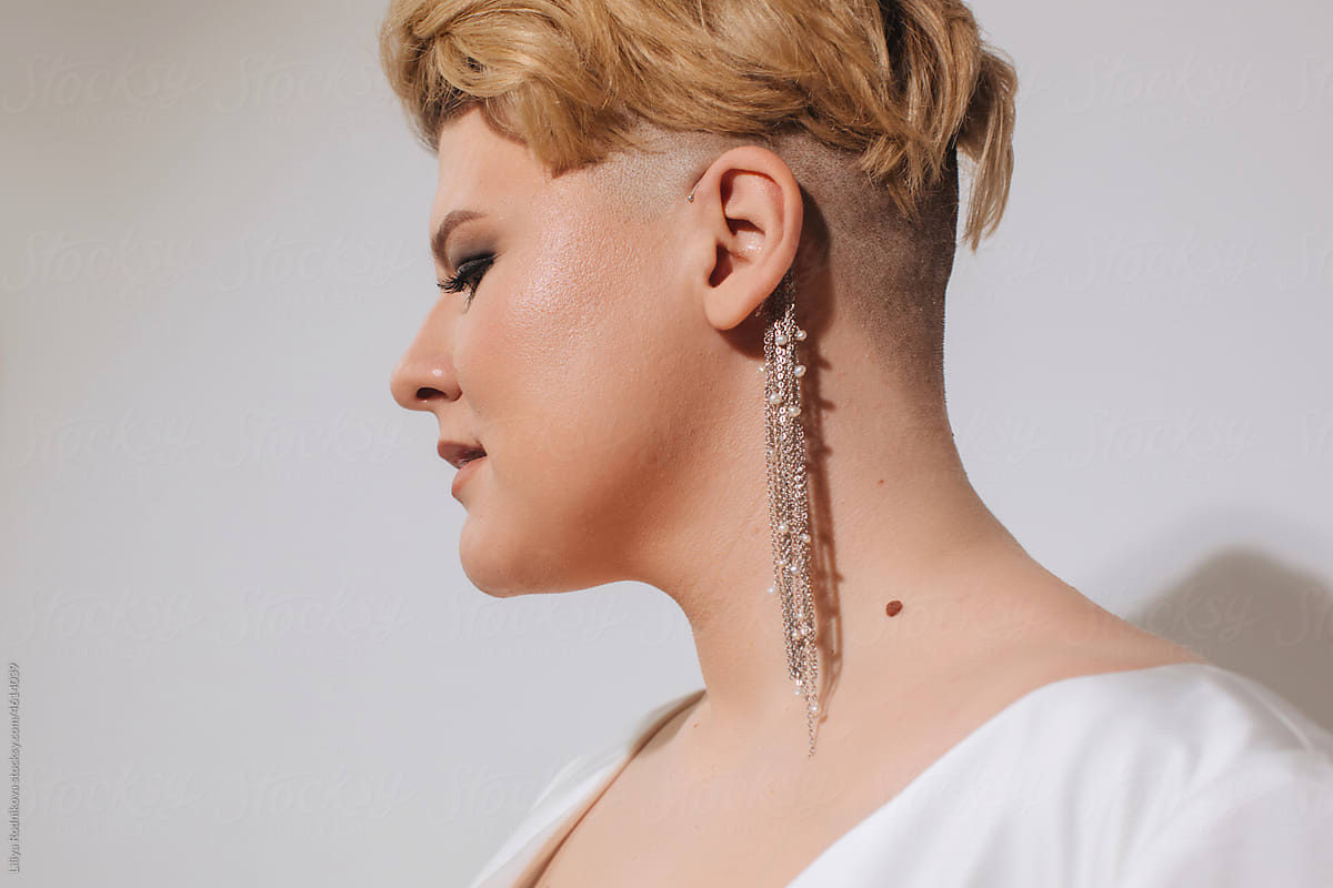 Stylish blond woman with silver earring