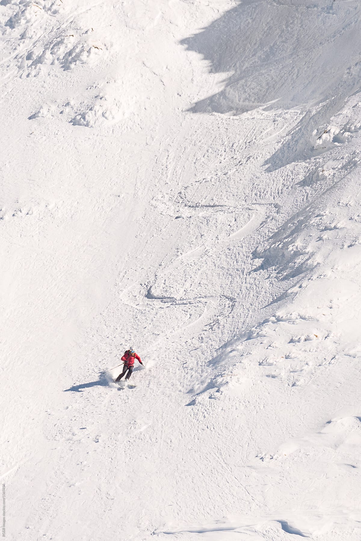 Person skiing off piste on a bright day