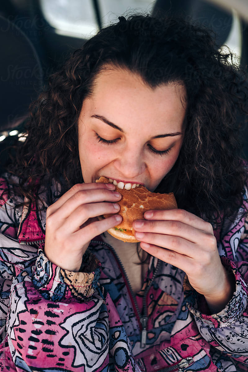 Teenager eating a hamburger