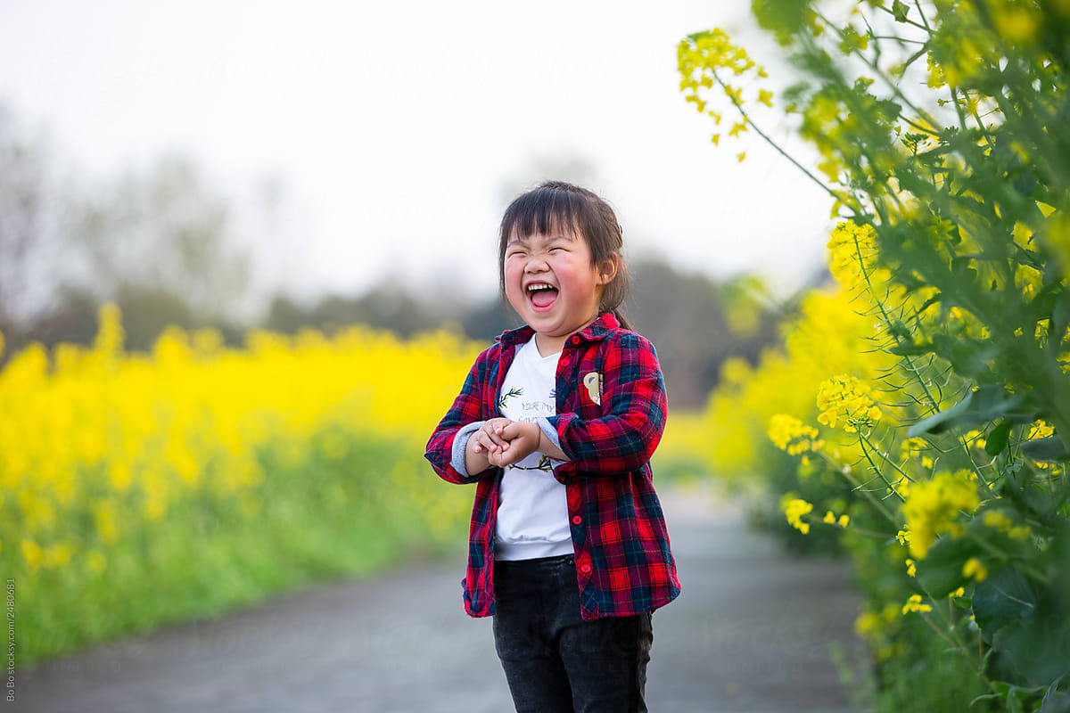 Happy little asian girl in spring field