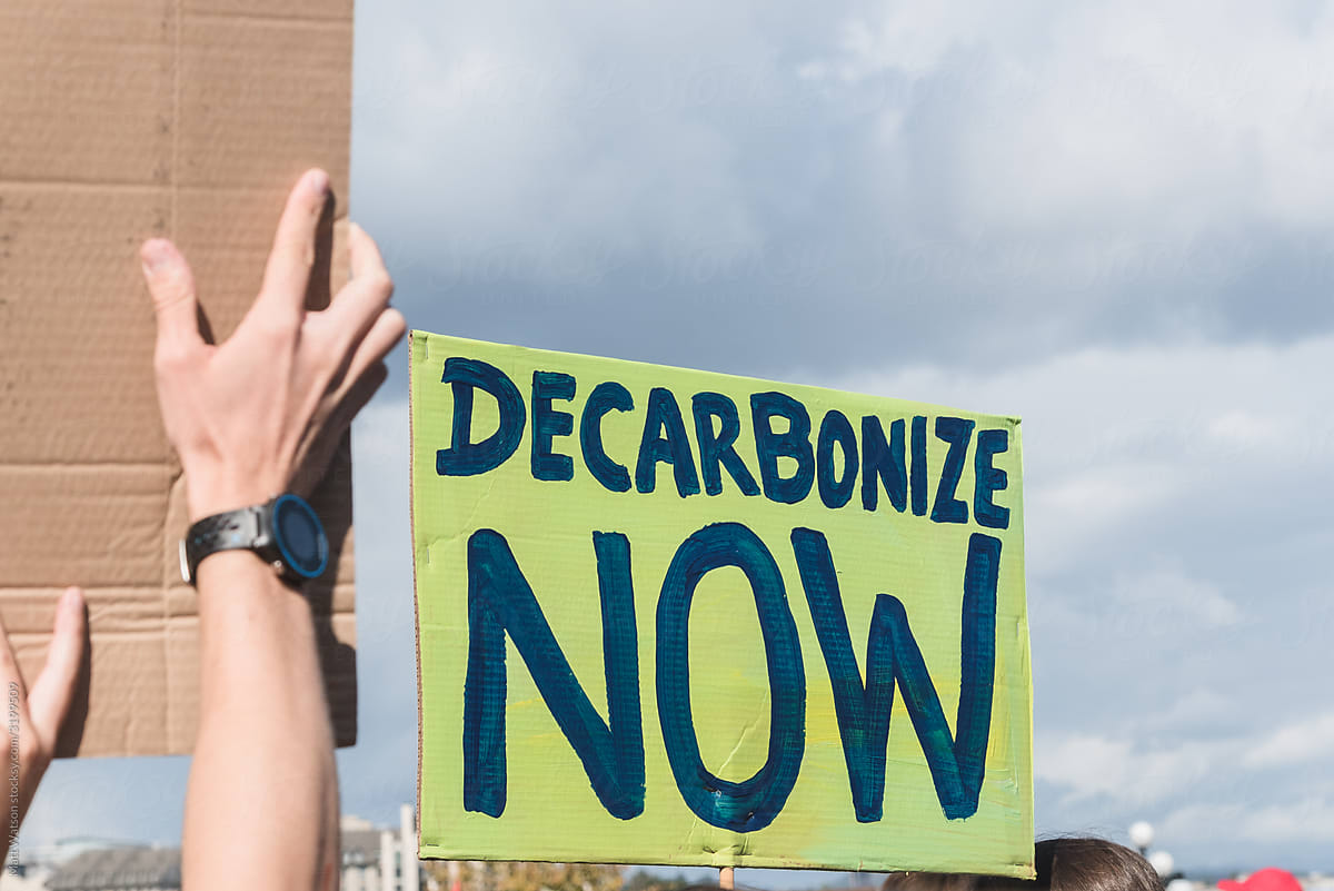 A climate protest sign reading \