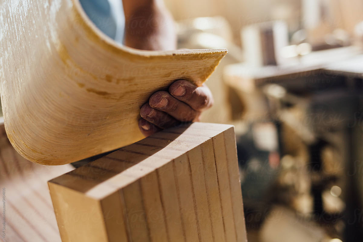 Woodworkers Hand Bending Plywood