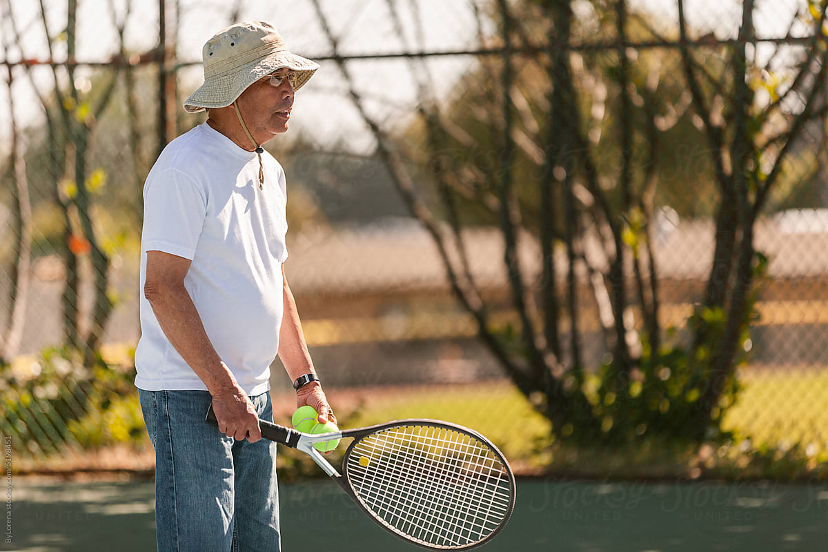 Senior man playing tennis outdoor