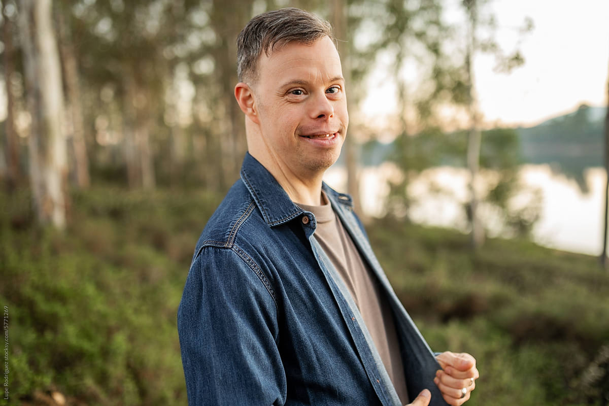 portrait of young man with down syndrome in nature