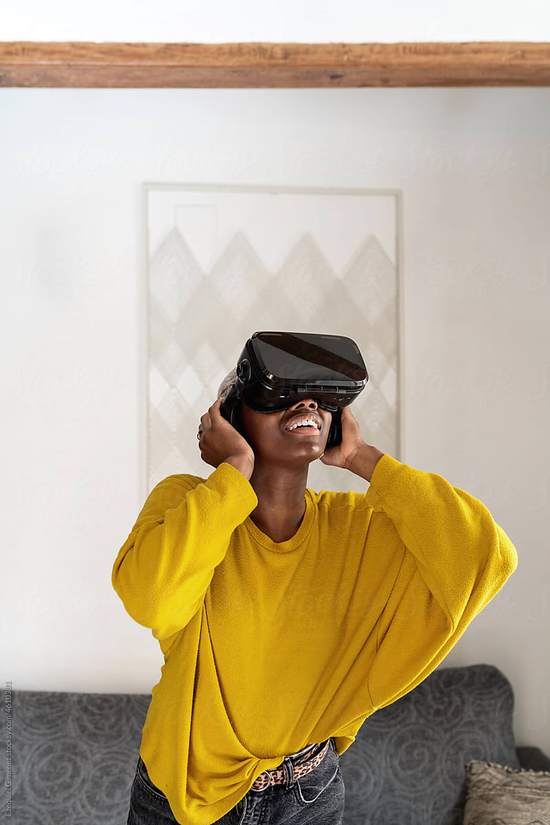 African American gamer enjoying sound in VR helmet