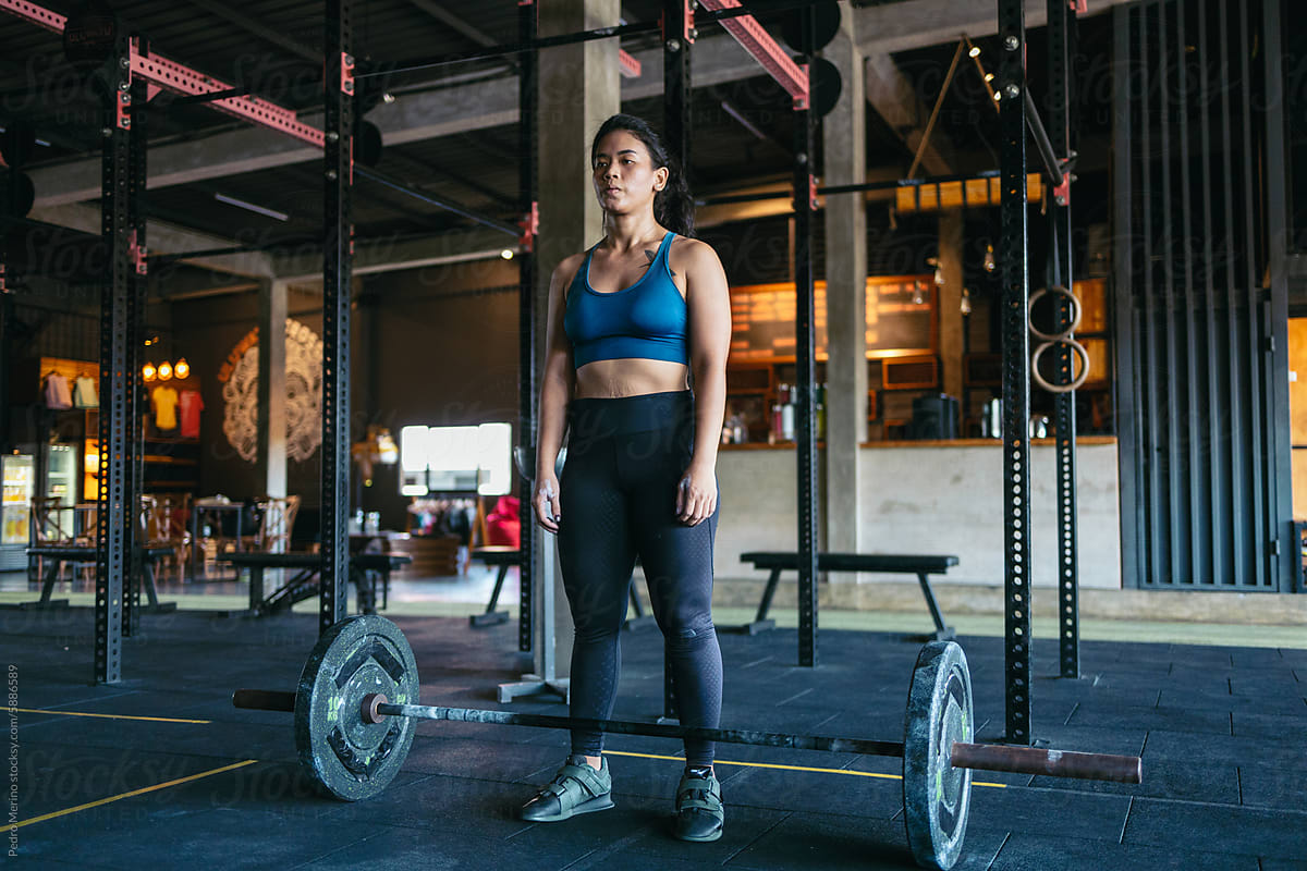Woman lifting weights in a CrossFit gym