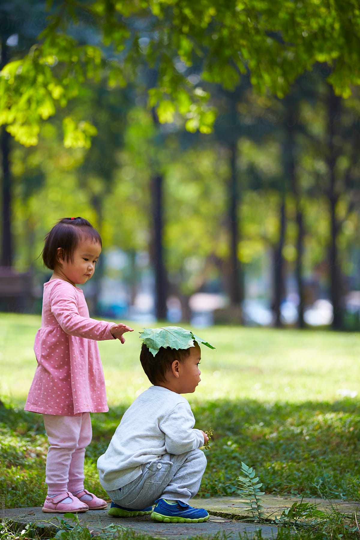 Happy Asian Kids Playing Outdoor In The Park by Stocksy Contributor Bo  Bo - Stocksy
