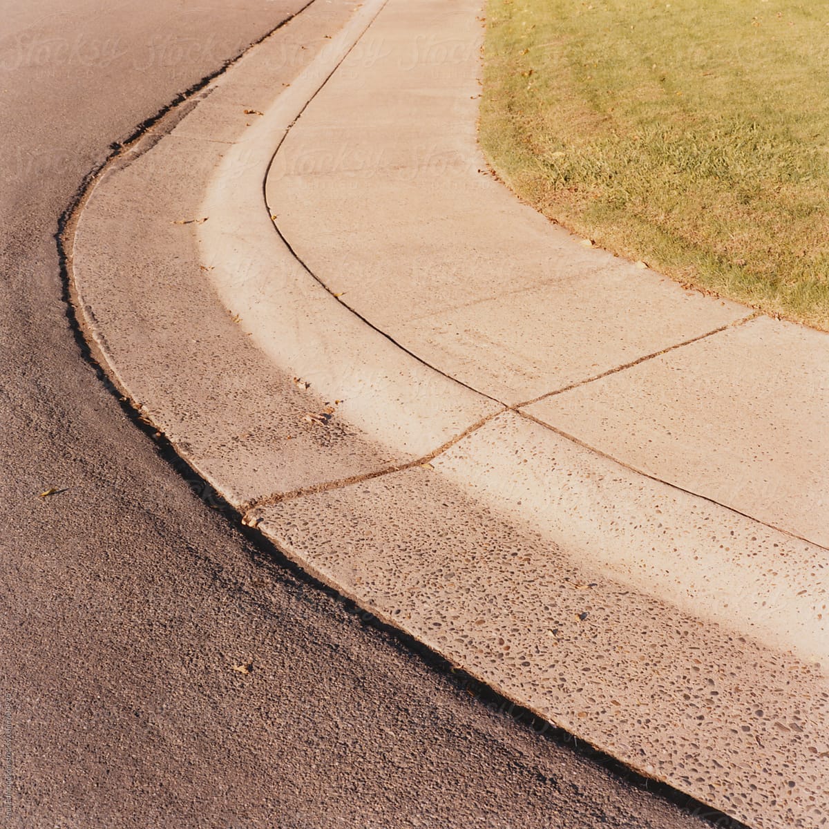 Detail of curving sidewalk along urban street