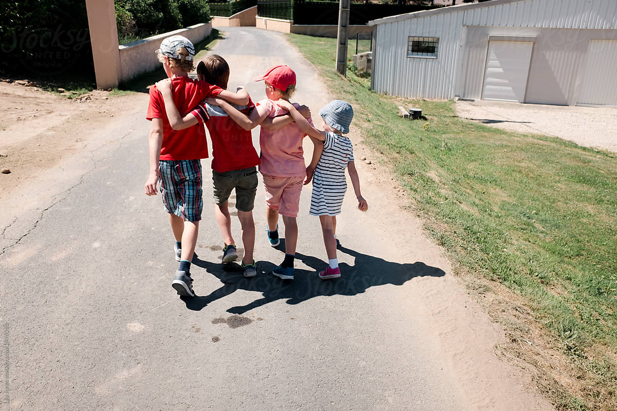 four kids walking with linked arms