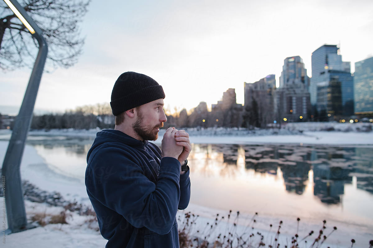 Active young bearded man training outside in winter.