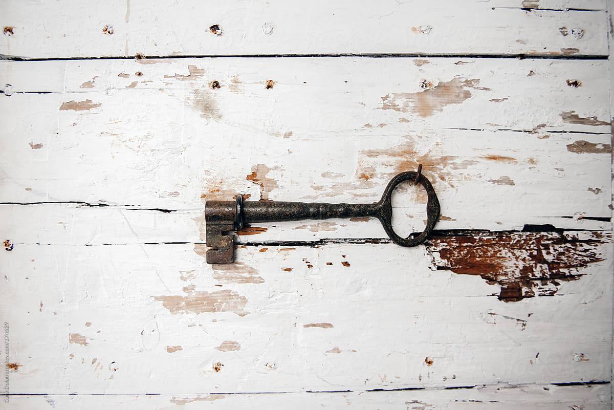 Antique key hanging on the wall of an old barn