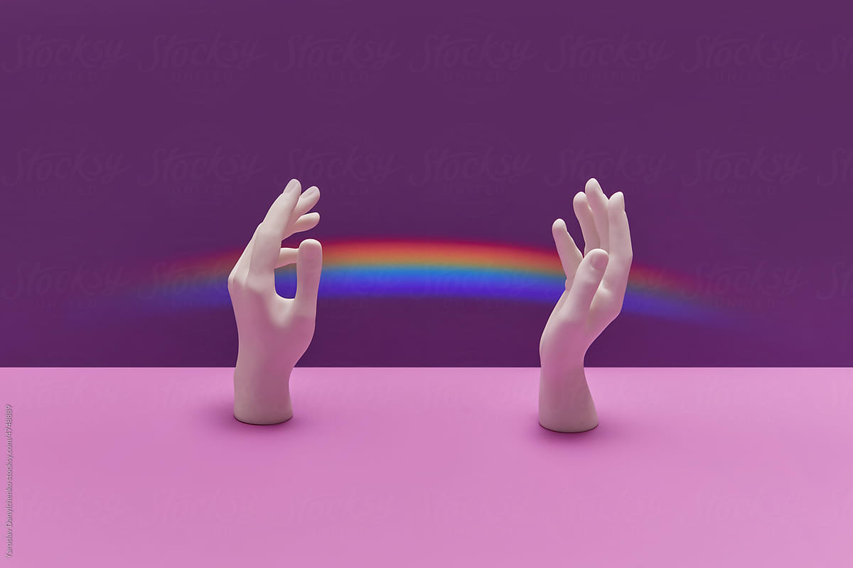 White plaster hands with bright rainbow.