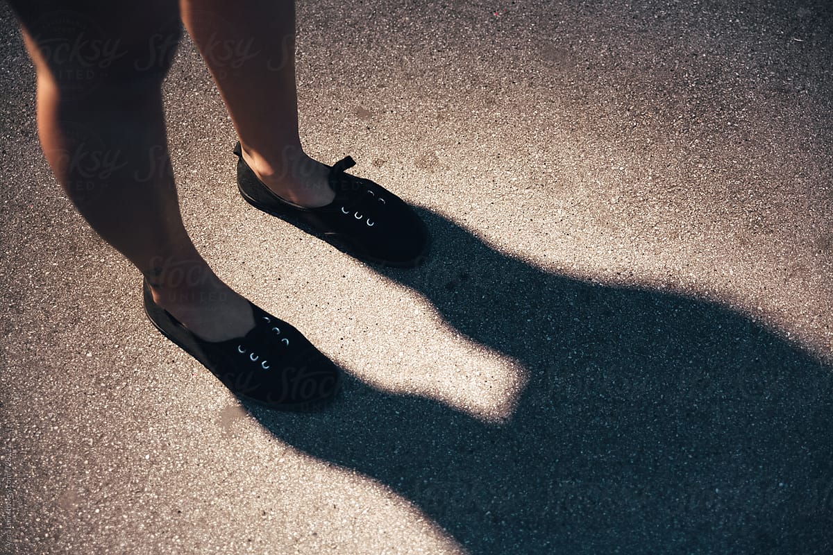 Woman legs in the shadow