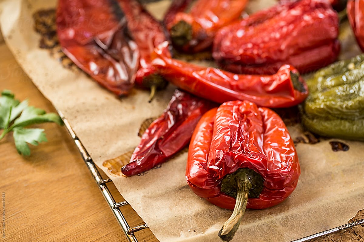 Red and green roasted peppers on baking paper