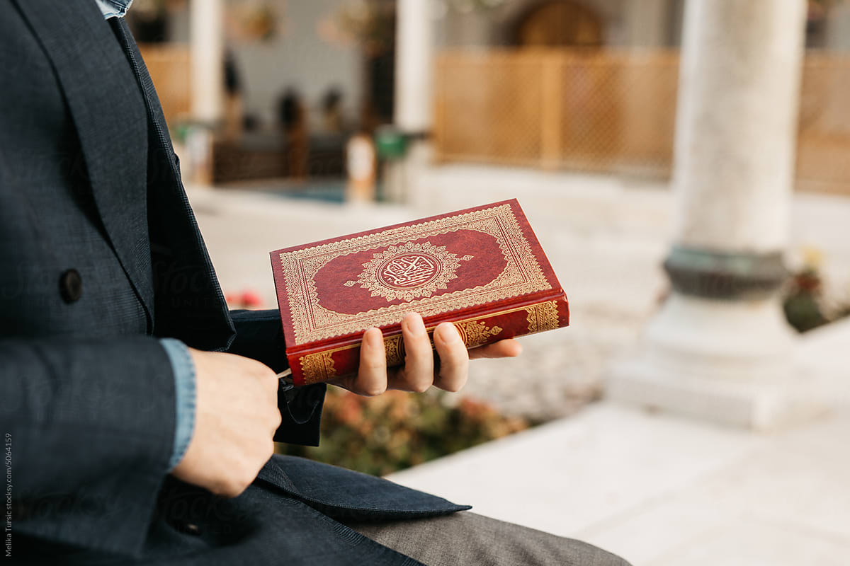 man holding Quran