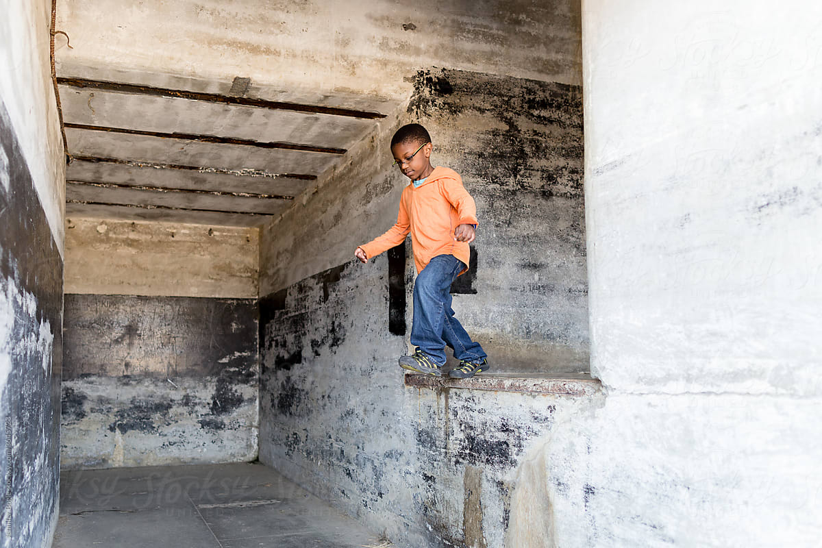 Boy leaps from concrete ledge