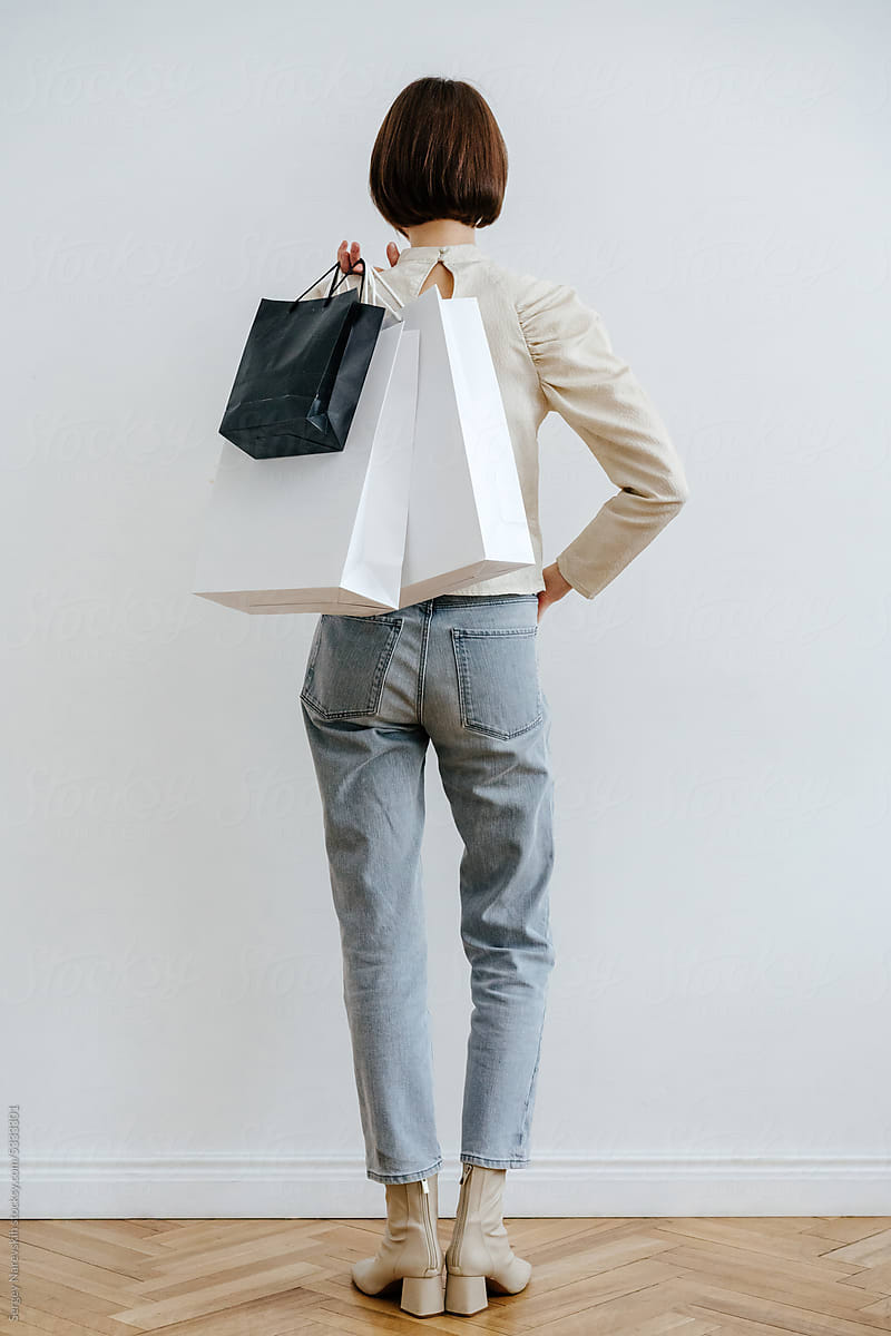 Unrecognizable female with shopping bags