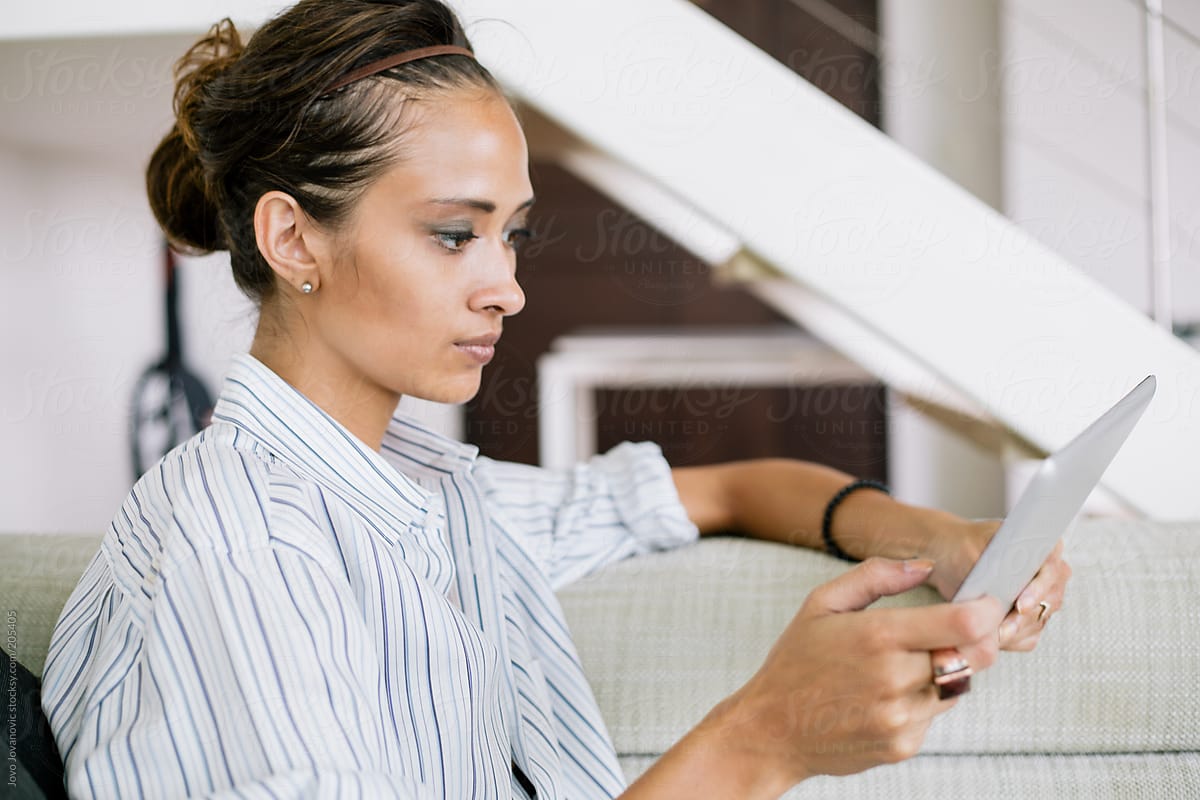 Woman using tablet in her living room