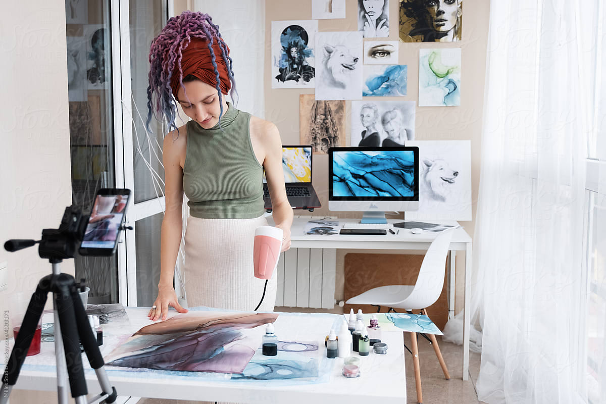 Female blogger drying fluid art on table