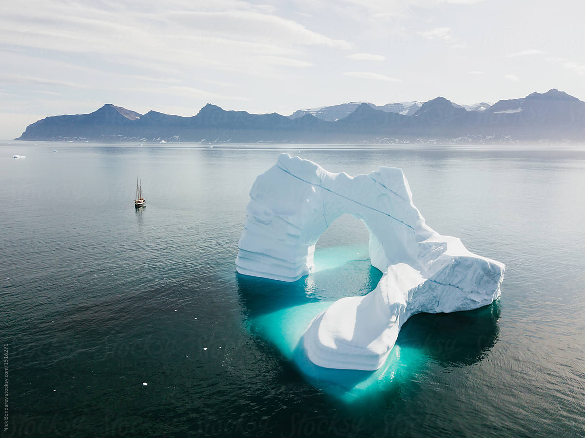 Aerial drone shot from above of Icebergs floating in the arctic close to greenland