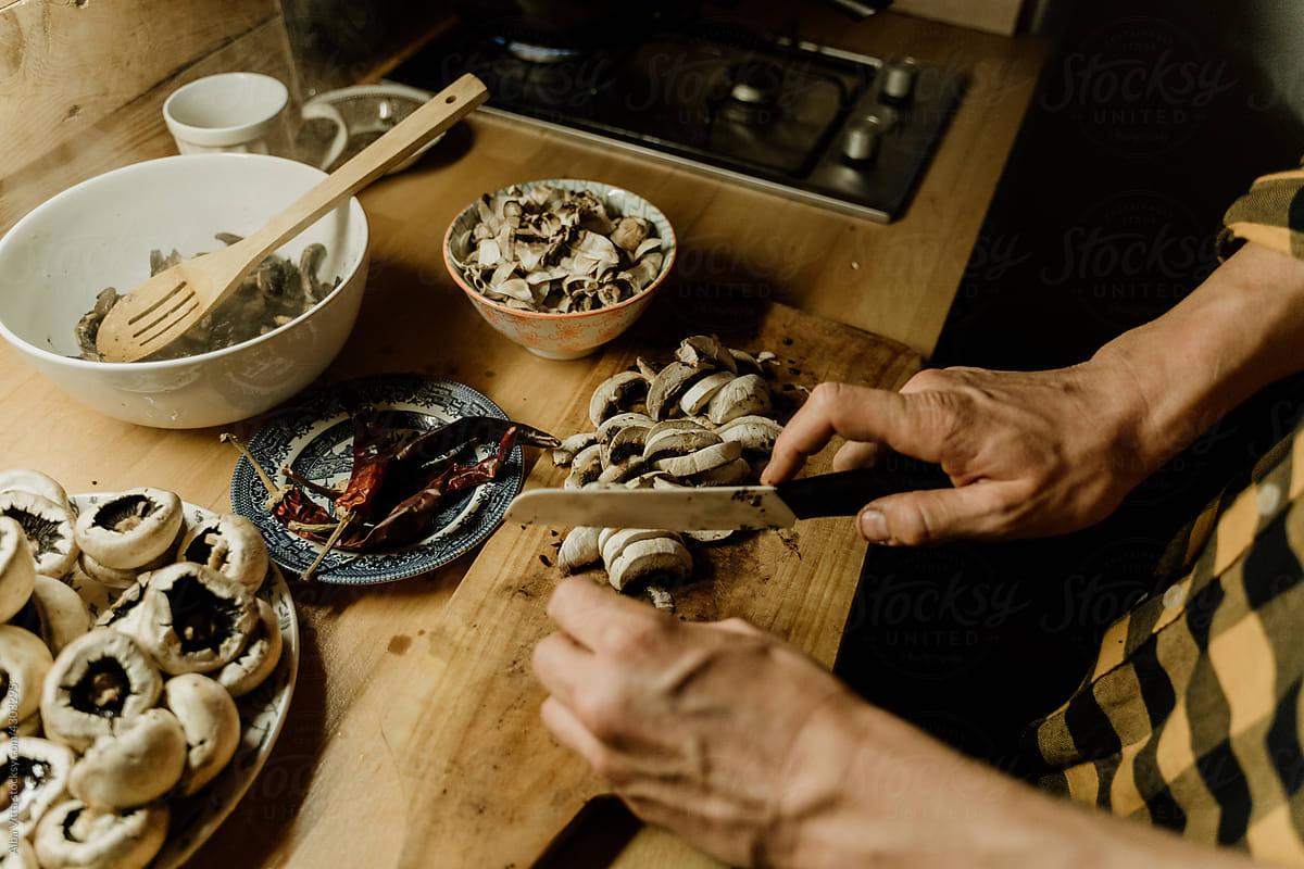 Man batch cooking mushrooms at home kitchen