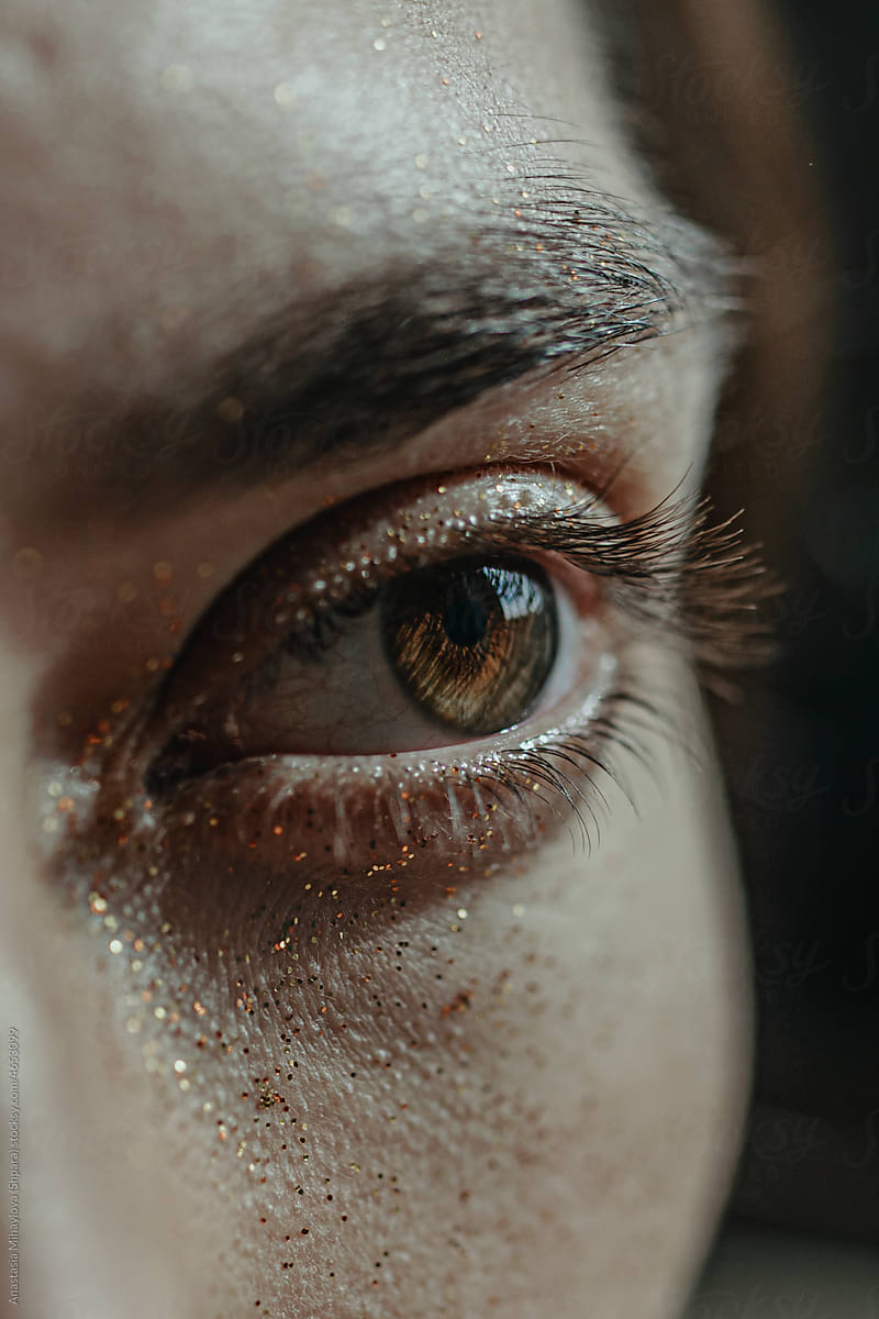 Detail - Close Up Of A Human brown Eye with Glitter on the Face