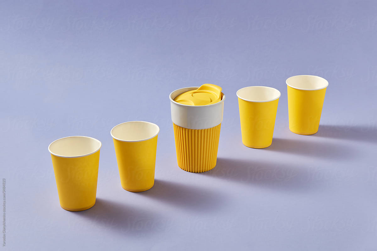 Set from paper cups and one reusable ceramic mug.