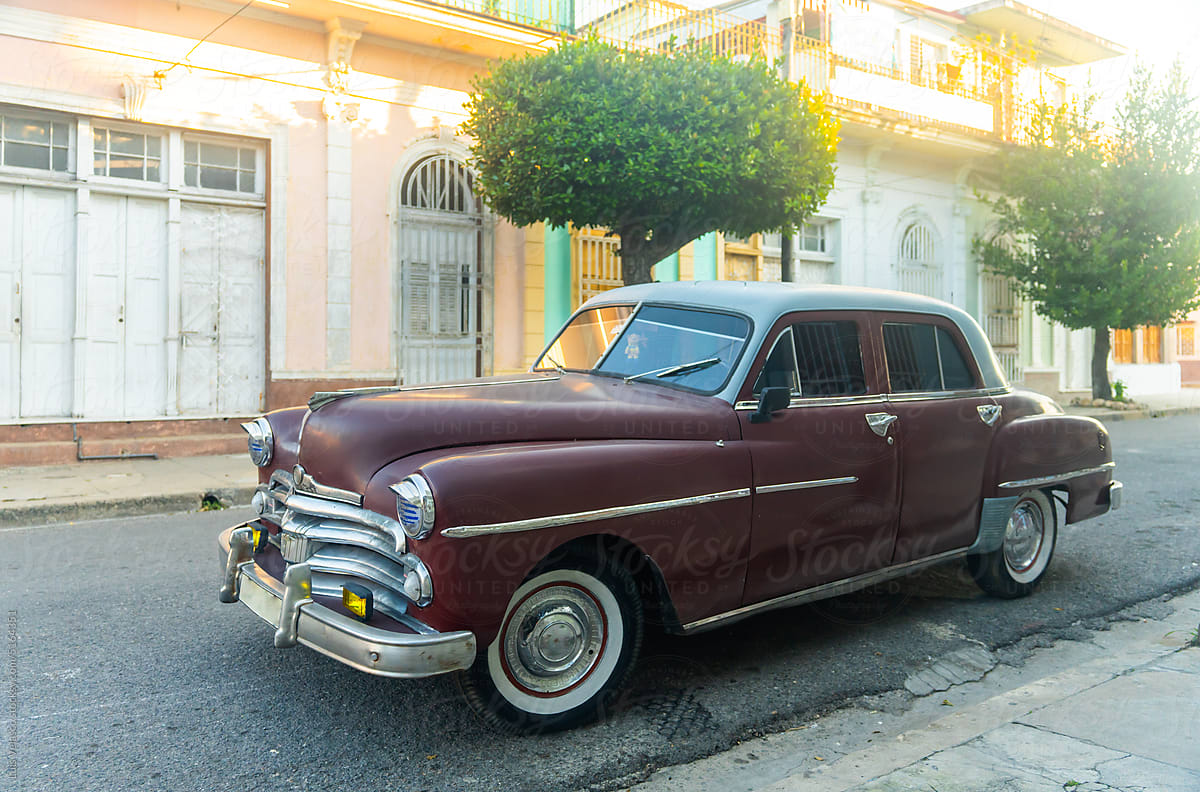 Brown Vintage Car Parked Near Antique Building In Cuba.