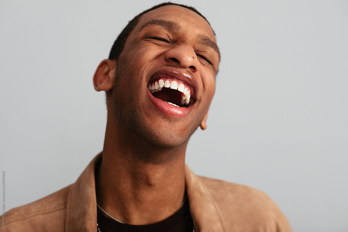Ethnic man laughing loudly in studio