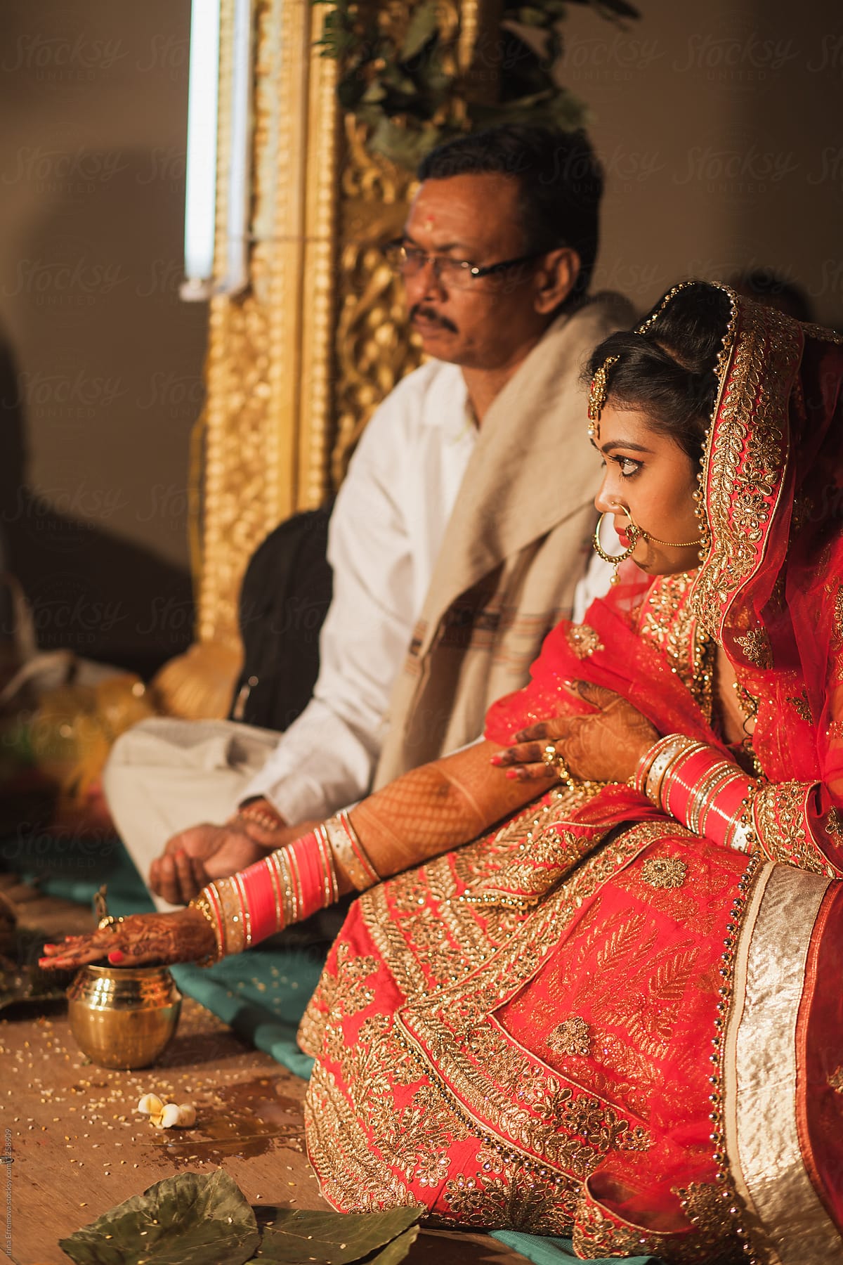 Indian bride and her father during the wedding ceremony