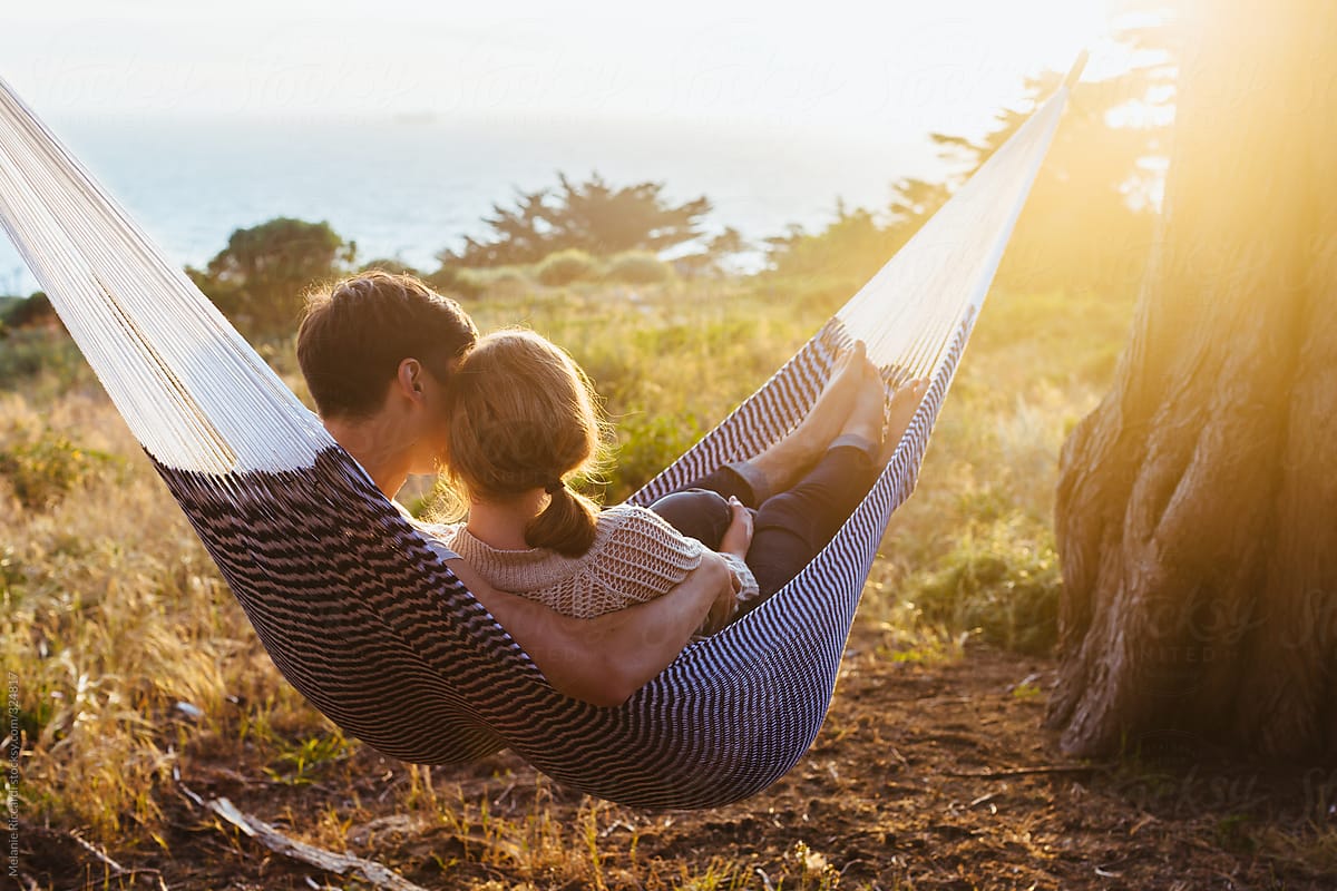 Couple cuddling in hammock