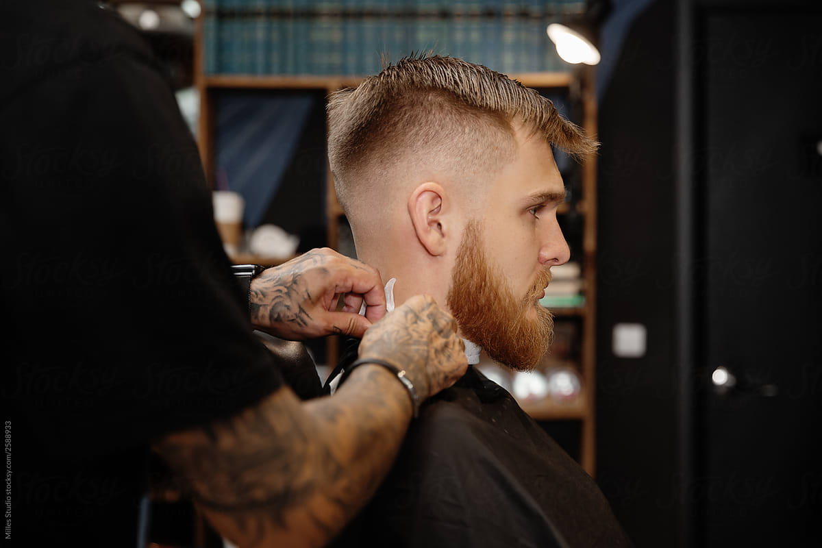 Professional barber working with man