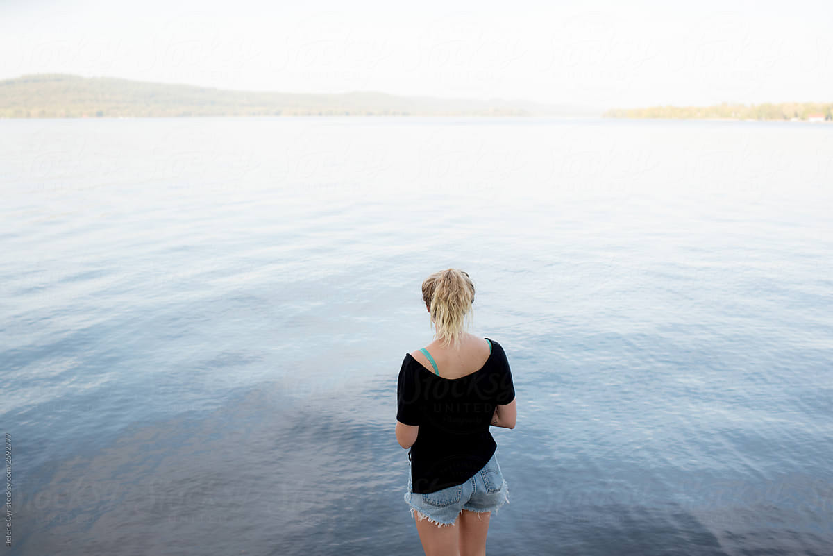 Young woman looking out onto the water