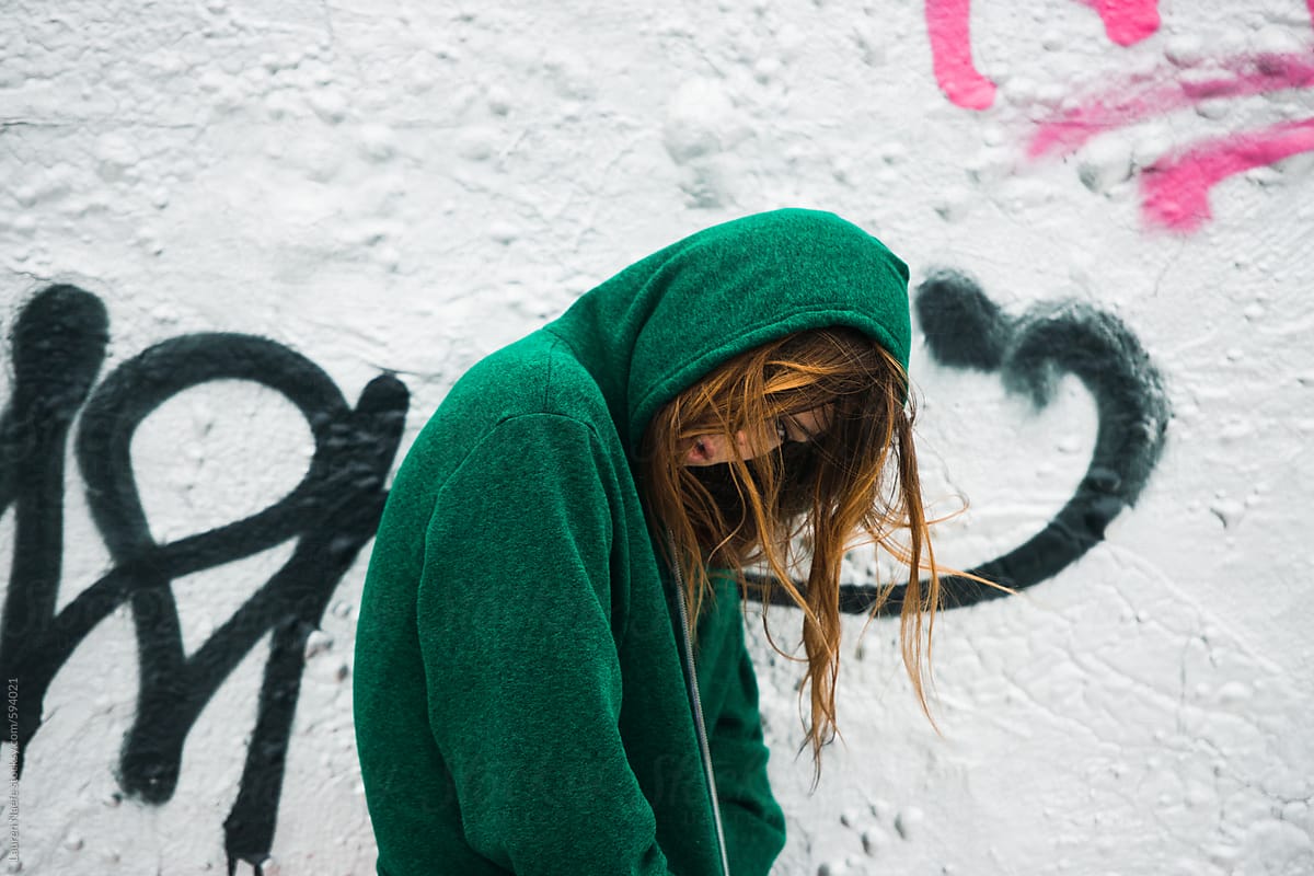 Girl in a hoodie with graffiti