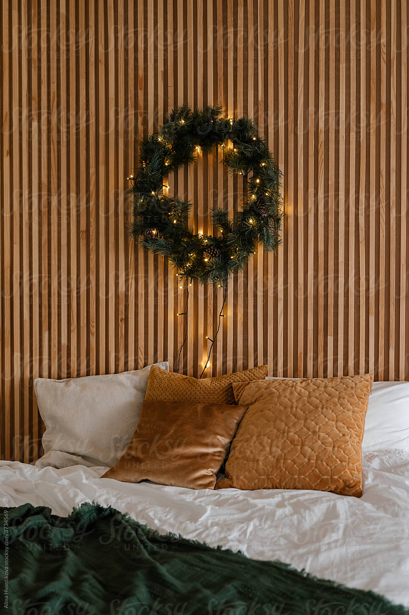 Christmas wreath hanging over bed