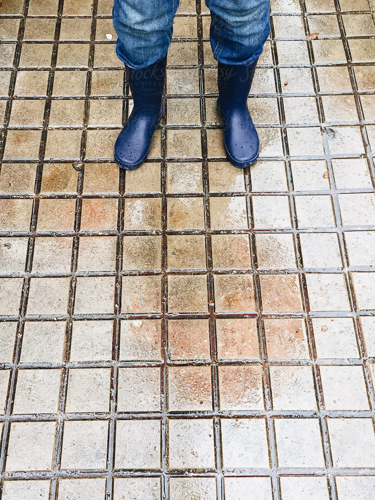 Kid with Water Boots on a Wet Floor