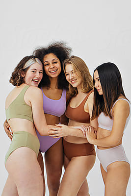 Diverse Models In Underwear Behind Woman Doing Yoga by Stocksy Contributor  Ivan Ozerov - Stocksy