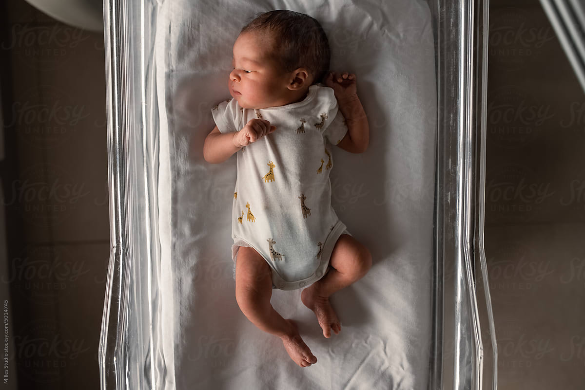 Infant in pajama in medical crib