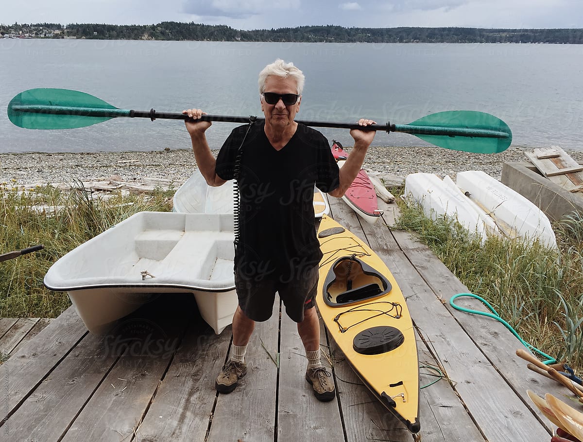 Man With Grey Hair Standing in Front of Boats