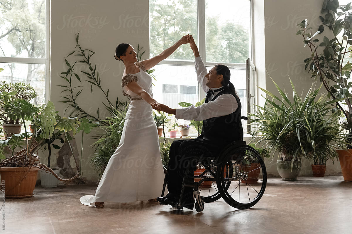 Woman dancing with cheerful partner with disability